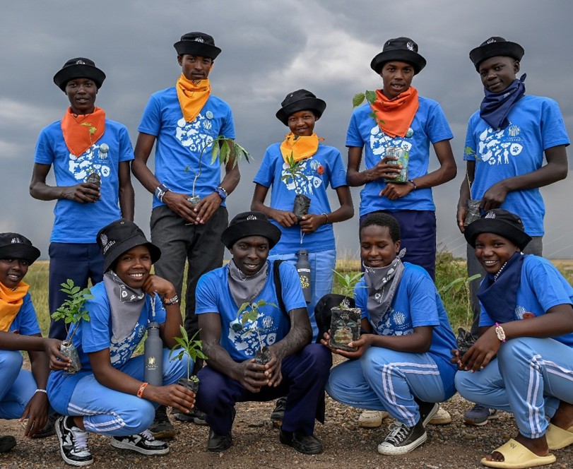 Children planning trees from the nursery Enkereri Primary School Kids Wilderness Kenya