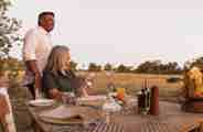 Guest dining while watching wildlife at Qorokwe