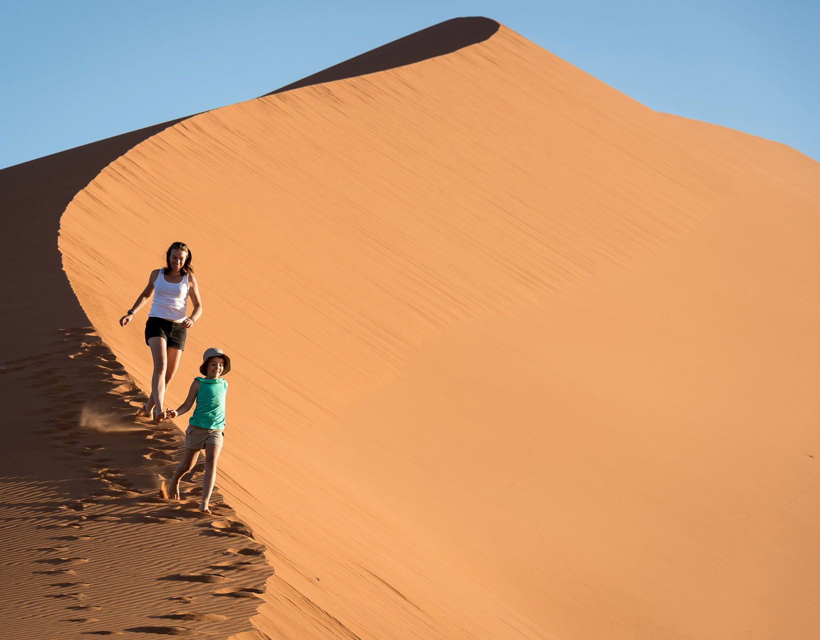 Wilderness Namibia Family Running on Dunes