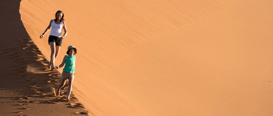 Wilderness Namibia Family Running on Dunes