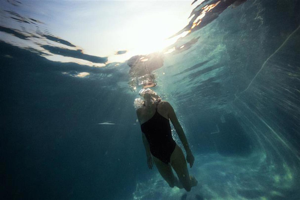 Underwater image of woman swimming at Mombo sanctuary pool