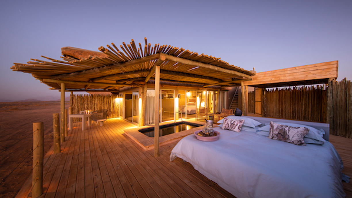 Little Kulala guest suite with Star Bed looking up at the night sky above the Namib Desert