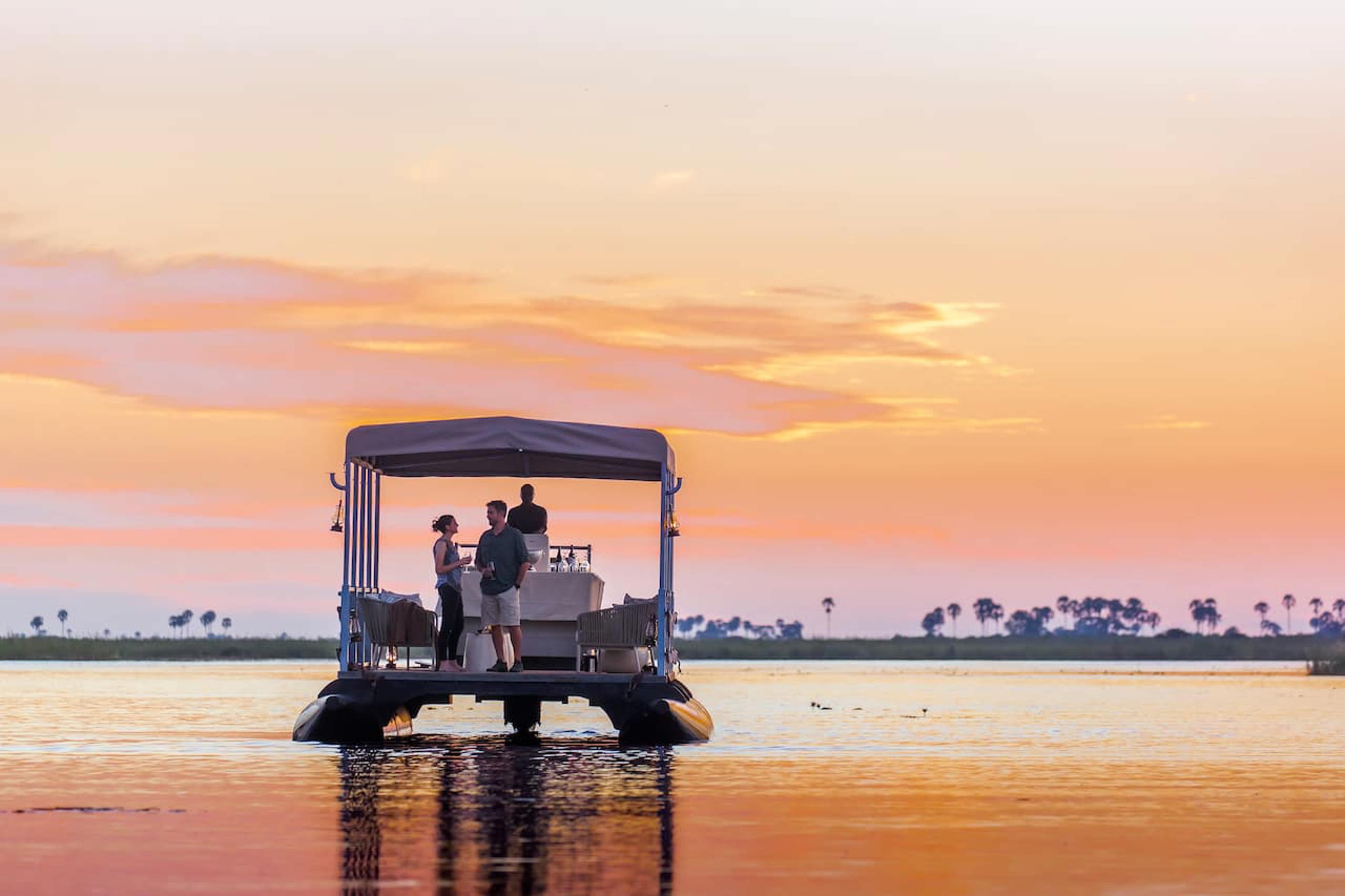 Couple on a barge on a lagoon at sunset