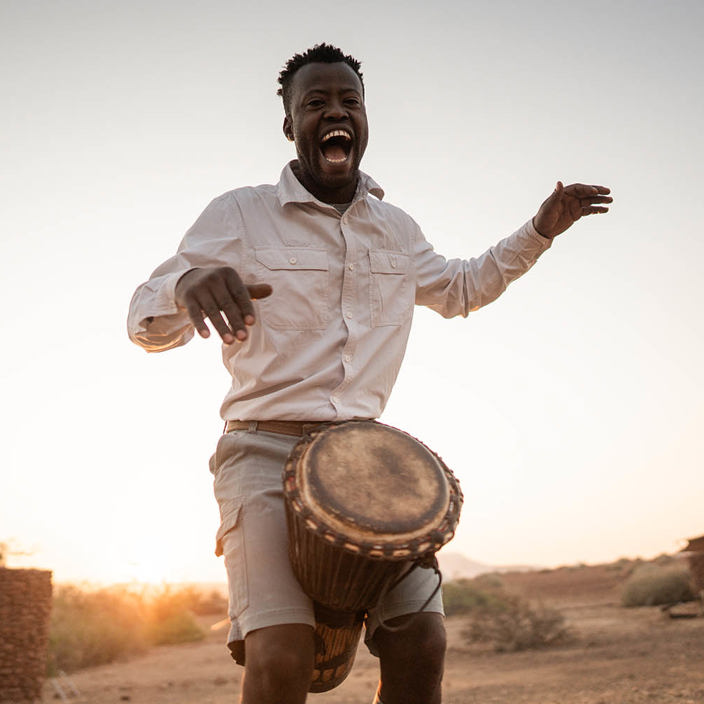 Staff in traditional dance at Wilderness Desert Rhino Camp