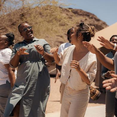 Hoanib Skeleton Coast Camp Staff Dancing with guest 