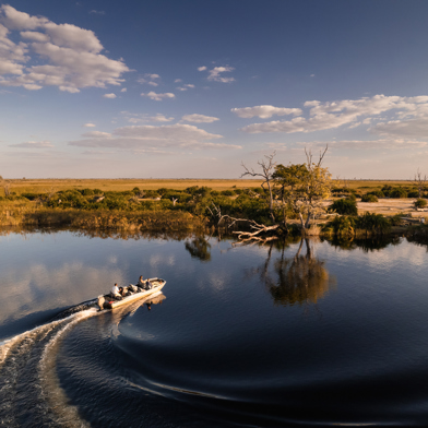 Boating in the channels of the Okavango Delta at Wilderness Little Vumbura