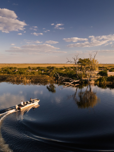 Boating in the channels of the Okavango Delta at Wilderness Little Vumbura