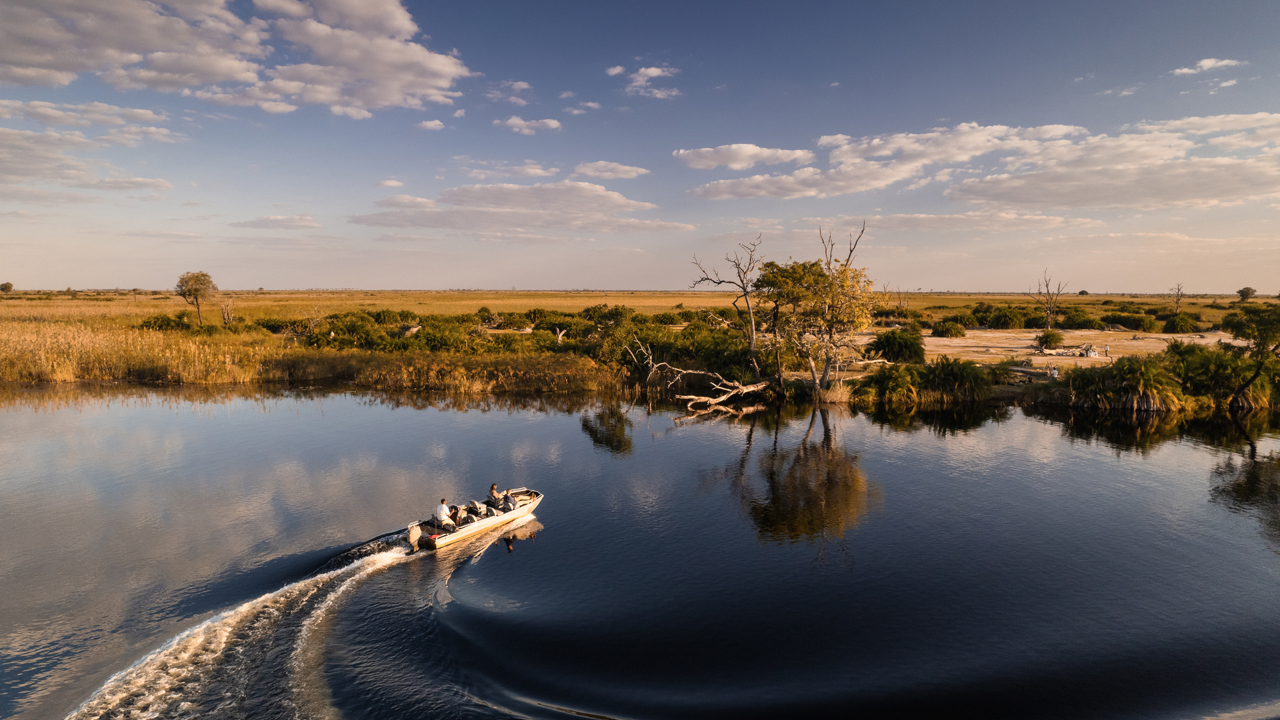 Boating in the channels of the Okavango Delta at Wilderness Little Vumbura