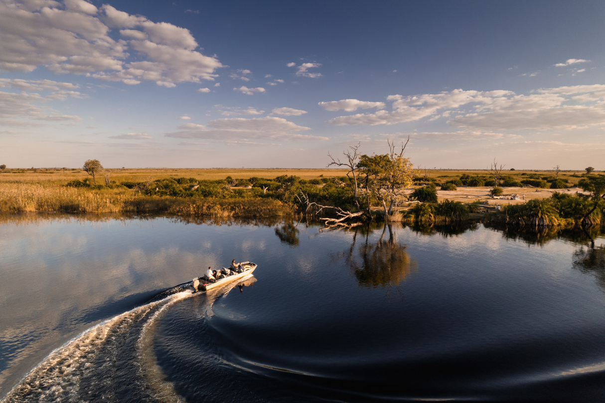 Boating in the channels of the Okavango Delta at Wilderness Little Vumbura