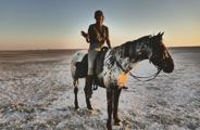 Woman Riding On The Makgadikgadi Pans In Botswana