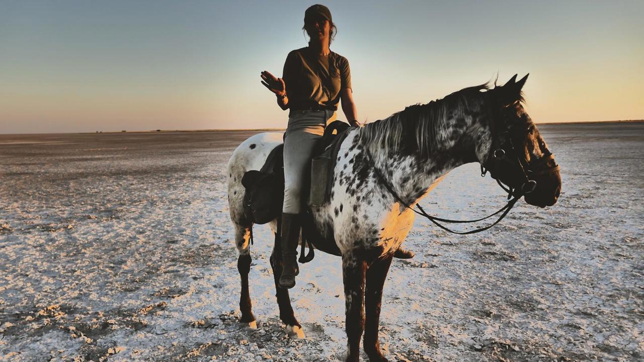 Woman Riding On The Makgadikgadi Pans In Botswana