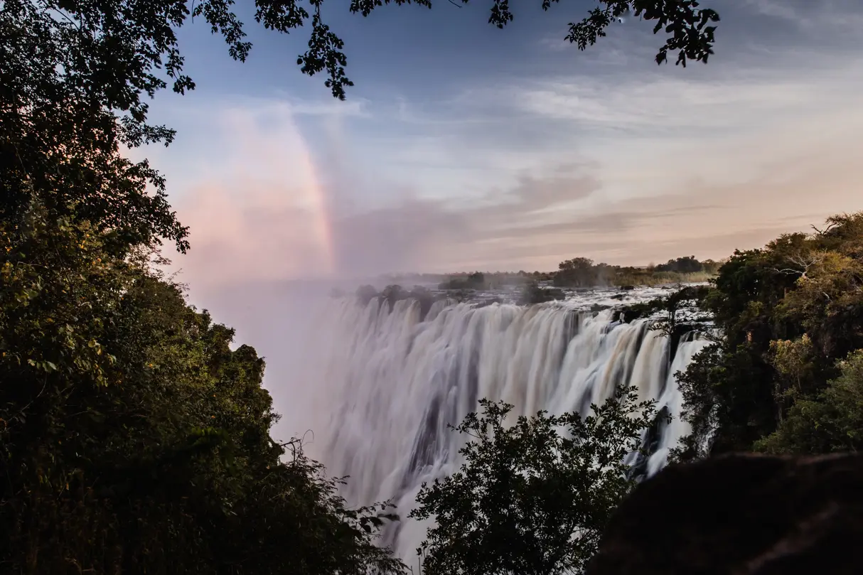 Rainbow over the might Victoria Falls as seen from the Zambian side