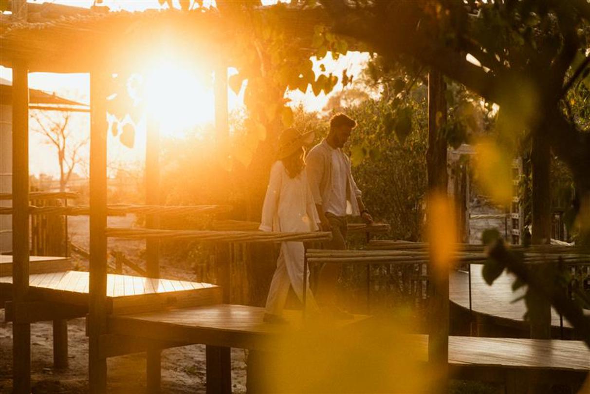 Couple walking on Wilderness Mombo walkway