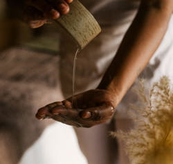 Therapist pouring oil oil into her hand