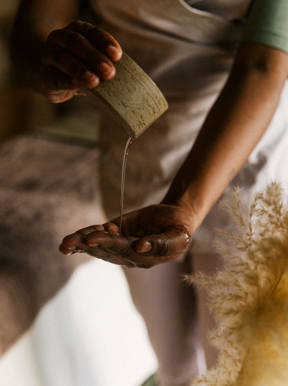 Therapist pouring oil oil into her hand