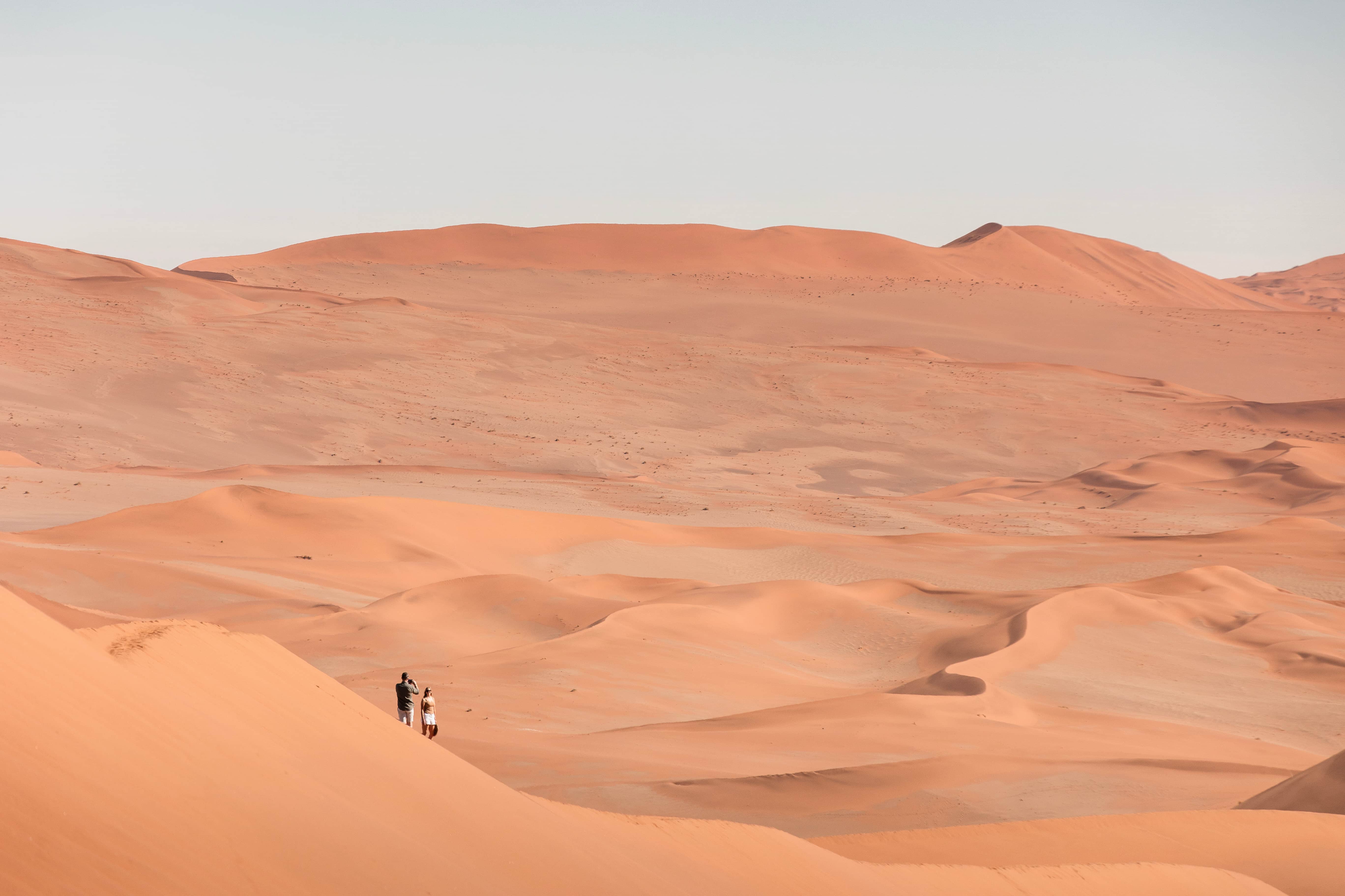 Two guests observing the beauty of the Dead Vlei at Wilderness Desert Lodge in Namibia