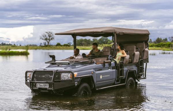 Wilderness game drive vehicles driver through the Okavango Delta channels