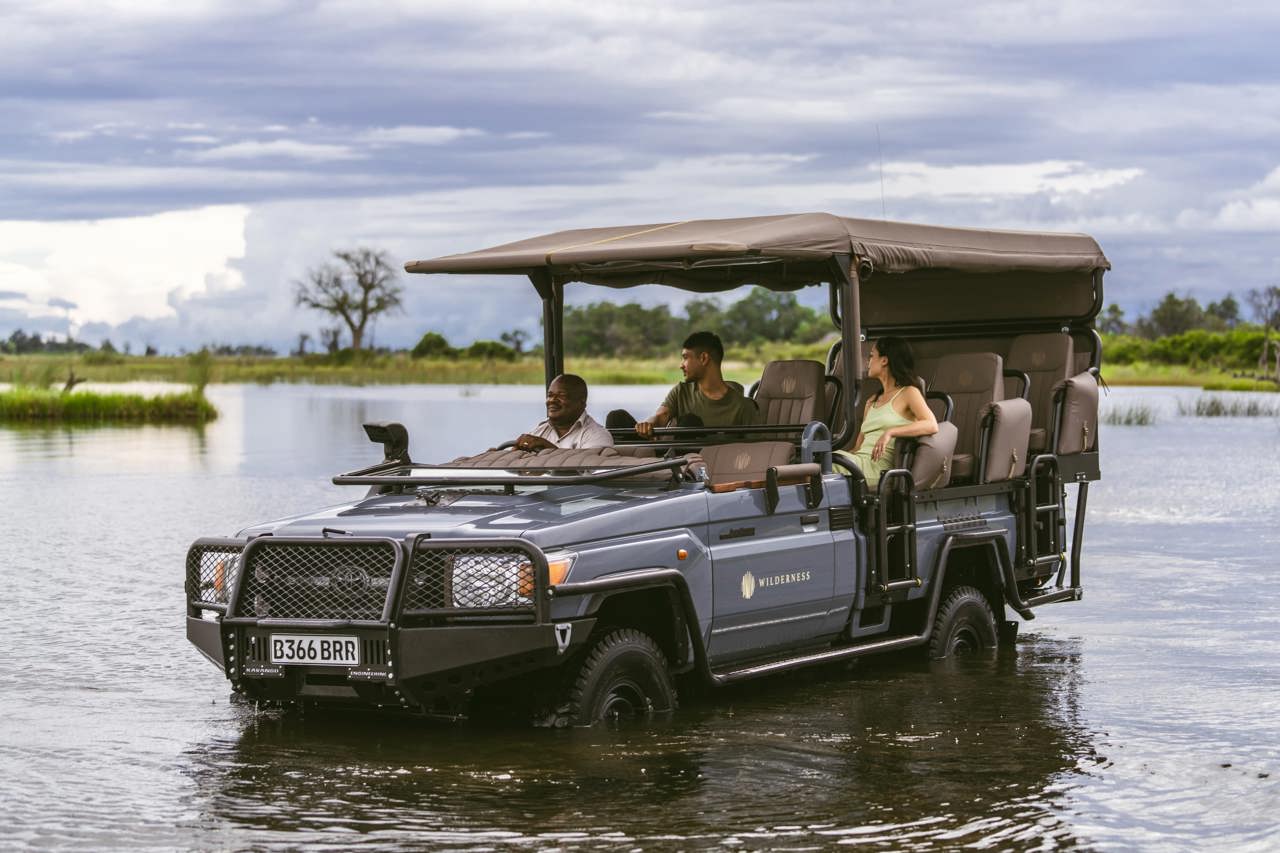 Wilderness game drive vehicles driver through the Okavango Delta channels