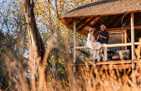 Guests enjoying some down time on the private deck of their tent at Wilderness Savuti