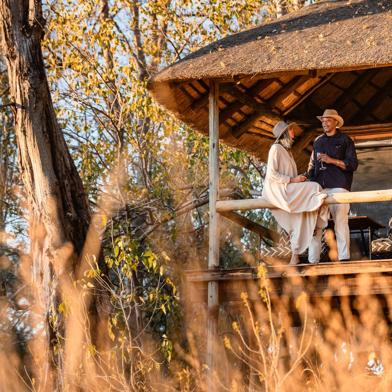 Guests enjoying some down time on the private deck of their tent at Wilderness Savuti