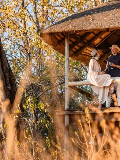 Guests enjoying some down time on the private deck of their tent at Wilderness Savuti
