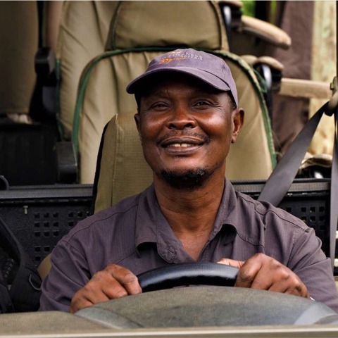 Profile of guide Peter Gava behind the wheel of a game drive vehicle