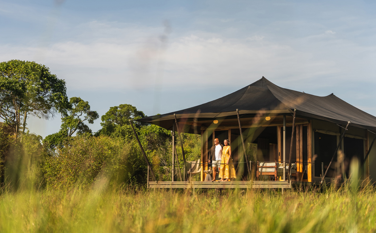 Guest enjoying the view from their private deck at Wilderness Mara, Kenya