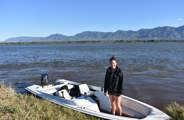 Woman on boat cruising down the Zambezi in Mana Pools 