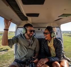 A couple enjoying a helicopter safari in Botswana