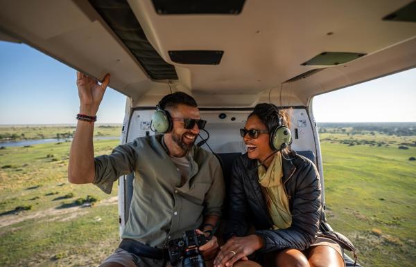 A couple enjoying a helicopter safari in Botswana