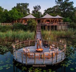 Floating jetty with camp fire Wilderness DumaTau