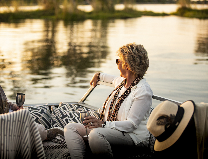 Two guests enjoying a boat cruise with sundowners in Wilderness Zambia Toka Leya