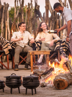 A traditional boma experience with local food and drink around a fire