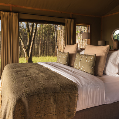 Bedroom interior of a guest tent at Wilderness Mara, Kenya