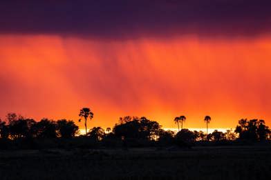 sunset and rainfall over botswana