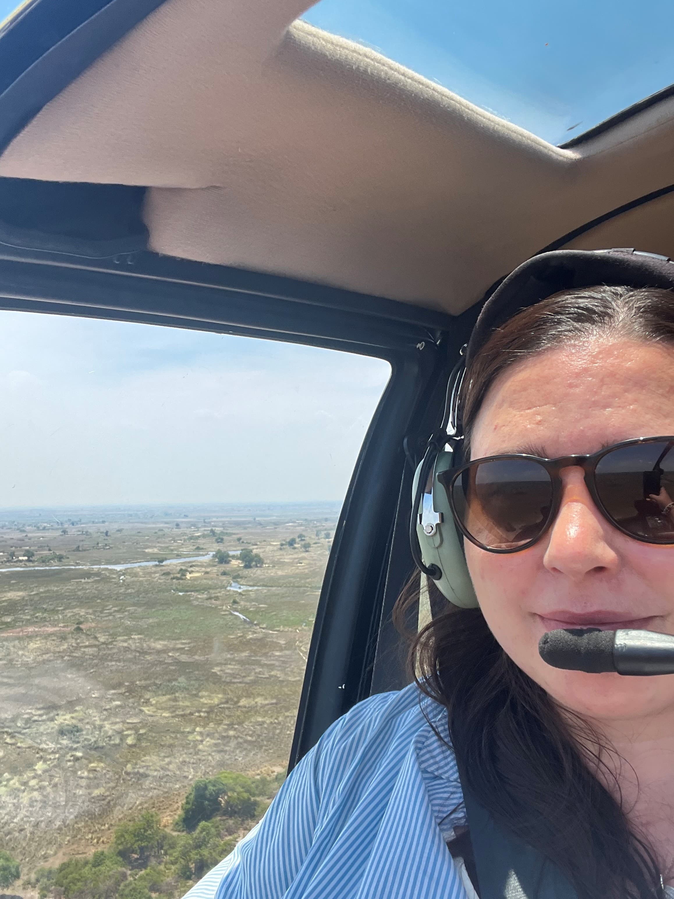 Woman posing in flight in a Helicopter Over The Okavango Delta