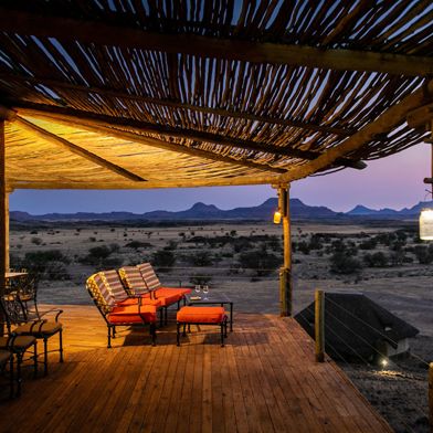 Wilderness Doro Nawas deck area overlooking the desert landscape at dusk