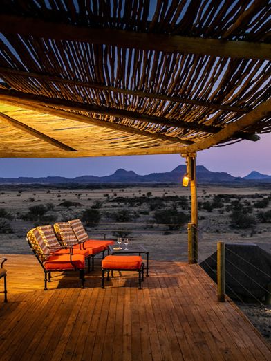 Wilderness Doro Nawas deck area overlooking the desert landscape at dusk