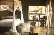 King bed in guest suite at Wilderness Shumba
