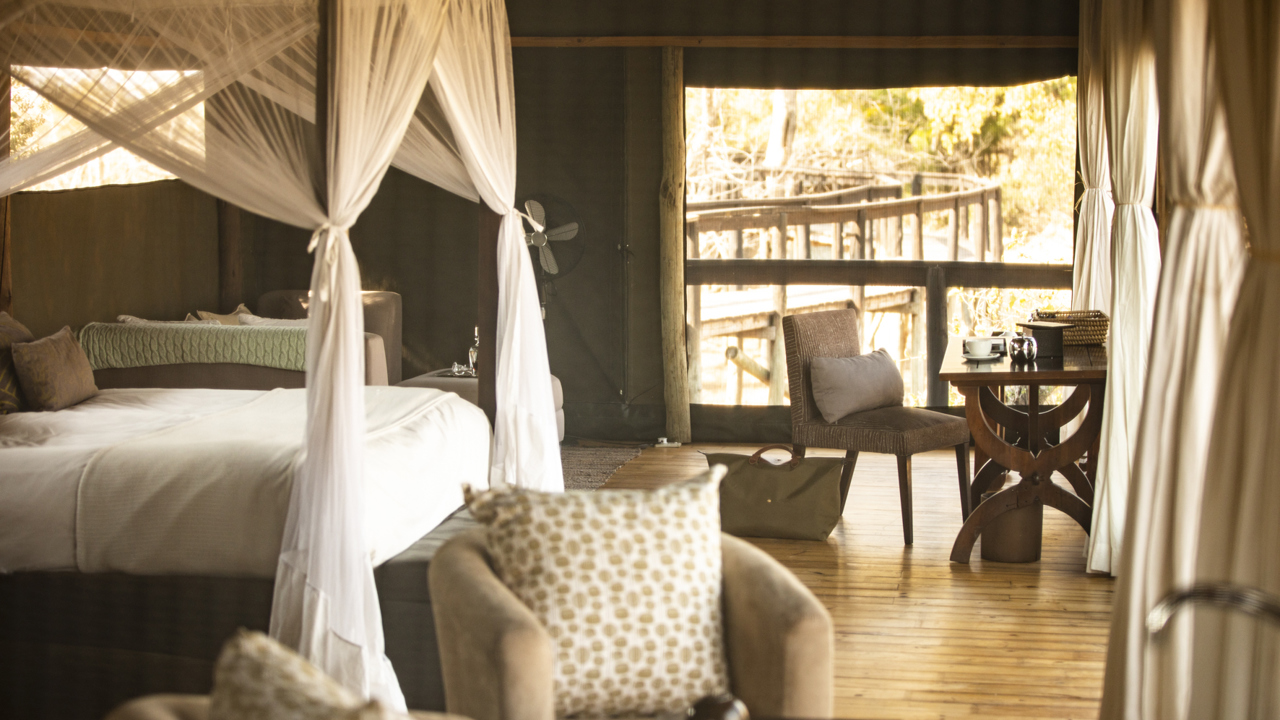 King bed in guest suite at Wilderness Shumba
