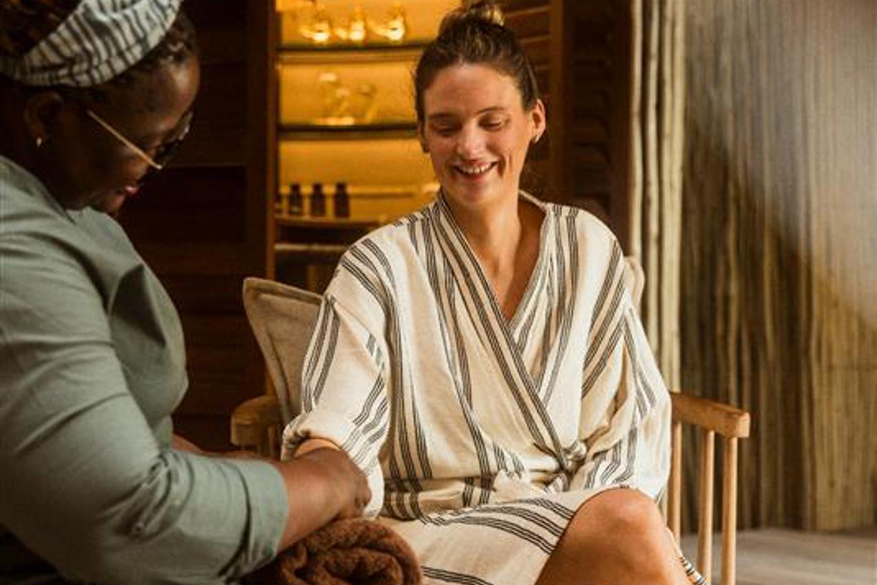 Woman enjoying hand ritual at Mombo sanctuary