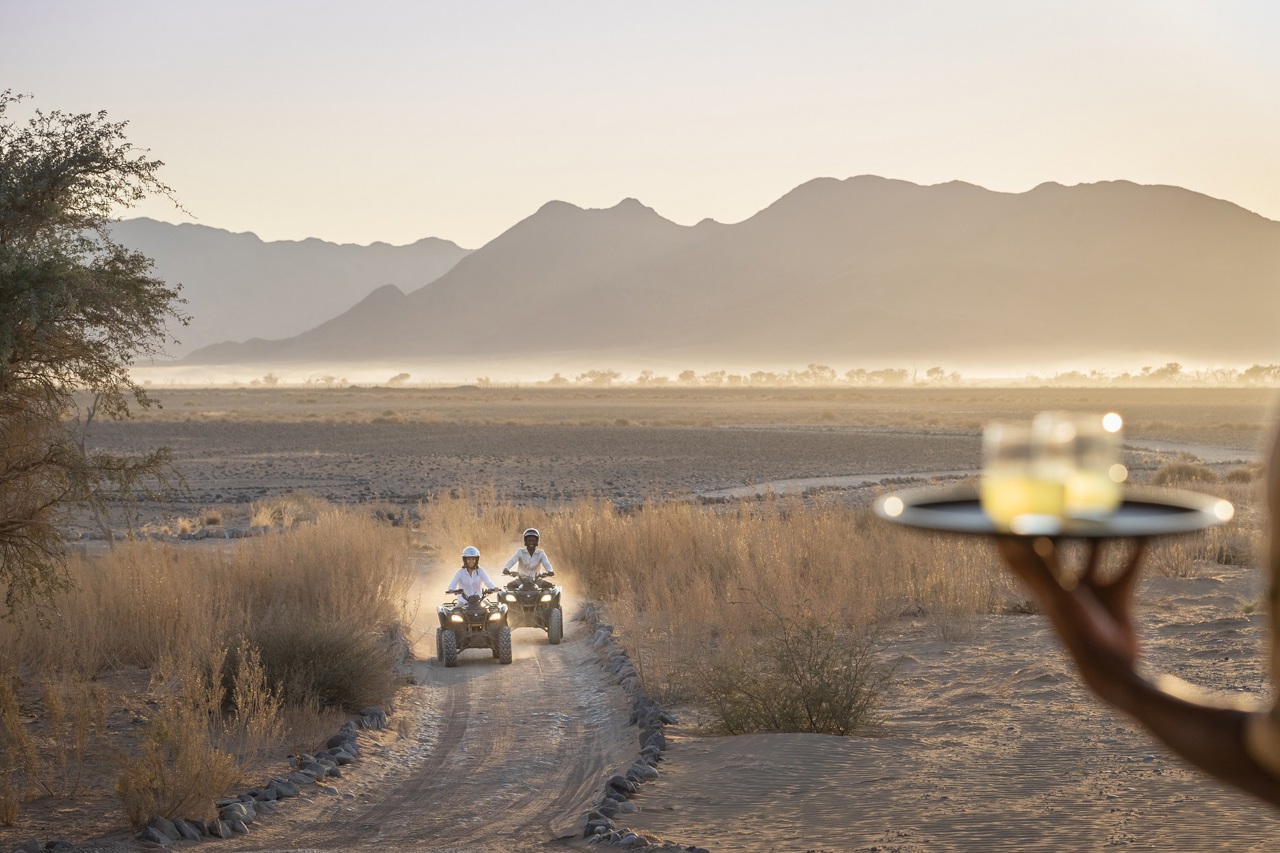 Desert safari lodge and quad biking surrounded by dunes in Namibia