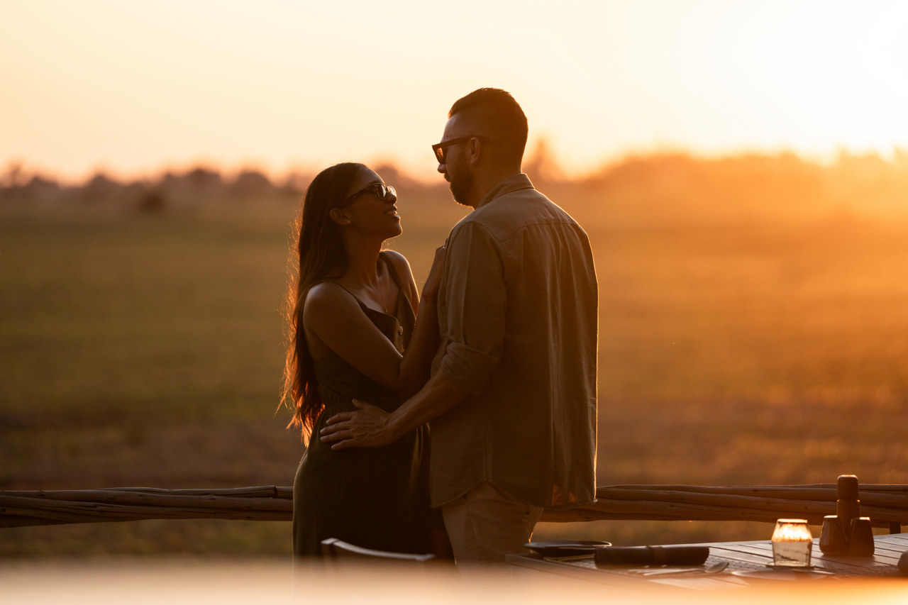 Honeymoon safari couple at sunset in Mombo Camp Botswana